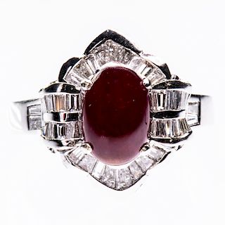 AN 18CT WHITE GOLD, RUBY AND DIAMOND RING, the oval cabocho