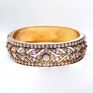 A VICTORIAN SEED PEARL AND DIAMOND BANGLE, the floral and f