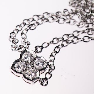 A DIAMOND PENDANT BY CARTIER, the simple flower head shaped
