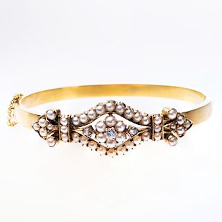 A MID 19TH CENTURY SEED PEARL SET BANGLE, the navette shape