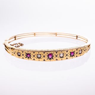A MID 19TH CENTURY RUBY AND DIAMOND SET BANGLE, the taperin
