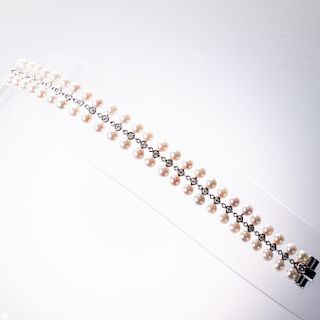 AN 18CT WHITE GOLD, CULTURED PEARL AND DIAMOND BRACELET, of