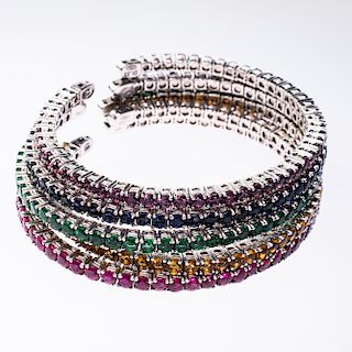 FIVE 18CT WHITE GOLD AND GEM SET BANGLES BY KESSARIS, each 
