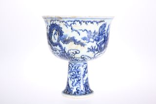 A CHINESE BLUE AND WHITE PORCELAIN STEM CUP, the bowl with 