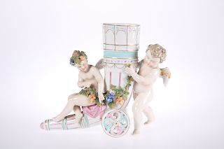 A CONTINENTAL PORCELAIN VASE, modelled as two frolicking pu