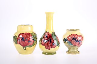 THREE PIECES OF MOORCROFT POTTERY IN THE HIBISCUS PATTERN, 