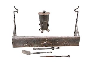 AN ARTS AND CRAFTS COPPER AND WROUGHT IRON FIRE SET, IN THE
