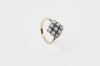 AN OPAL RING, the square shaped mount set with nine round c