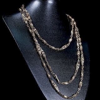 A VICTORIAN GUARD CHAIN, of pierced decorative links on Alb