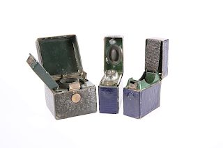 THREE EDWARDIAN TRAVELLING INKWELLS, each leather covered a