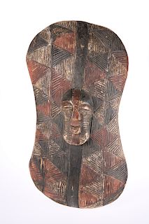 A "NGABO" SHIELD DECORATED WITH A KIFWEBE MASK IN RELIEF, S