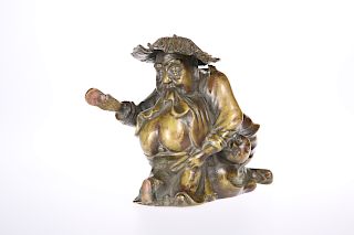 A CHINESE BRONZE FIGURE GROUP, cast as a man slapping the n