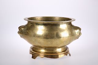 A CHINESE BRASS PLANTER, engraved with characters and with 