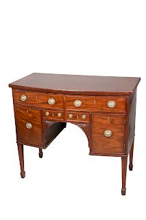 A SMALL REGENCY MAHOGANY BOW-FRONT SIDEBOARD, with an arran