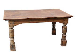 AN OAK TABLE, with boarded top, raised on cup and cover leg