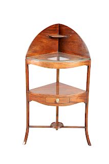 A GEORGE III MAHOGANY CORNER WASHSTAND, bow-fronted, the sh