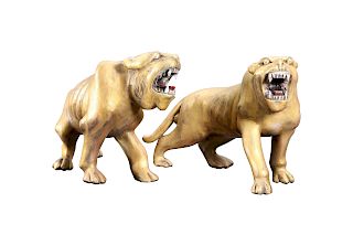 A PAIR OF CARVED AND GILDED TIGERS, each beast modelled in 