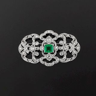 A 18K white gold, diamond and emerald brooch