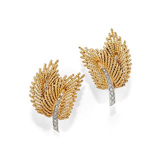 A 18K two color gold and diamond earring