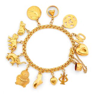 A yellow gold bracelet with charms