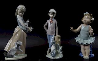 collection of three lladro porcelain figures