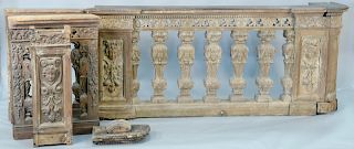 Carved victorian railing having large spindle with carved wheat design and carved panels with putti figures.