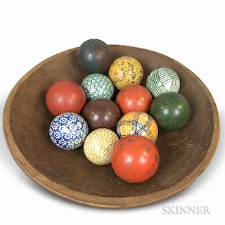 Red-painted and Turned Pine Bowl and Twelve Wood and Ceramic Carpet Balls