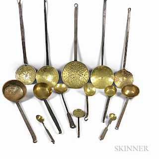 Fourteen Iron and Brass Skimmers and Ladles