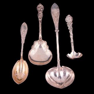 Four sterling serving spoons.