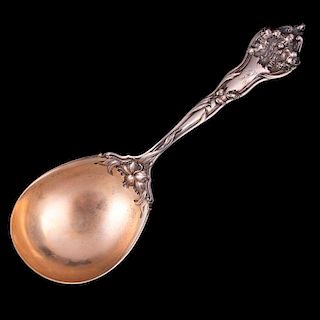 A large sterling serving spoon.