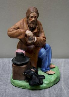 Russian Porcelain Figure of a Seated Man.