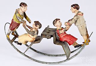 Early painted tin clockwork seesaw toy