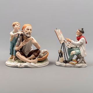 Lote de 2 figuras decorativas. Siglo XX. Elaboradas en porcelana. Acabado gres. Consta de: pescador con niño y pintor. 20 x 20 x 15 cm.
