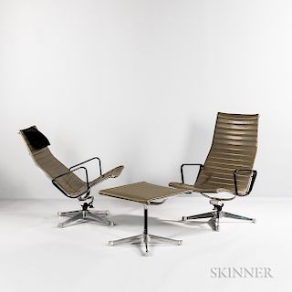 Two Eames Aluminum Group Lounge Chairs and an Ottoman