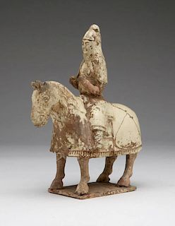 A ceramic horse and armored rider tomb figure