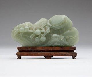 A Chinese celadon-colored jadeite jade carving