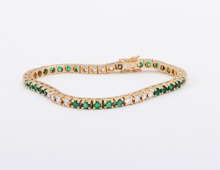 Ladies 18kt. yellow gold diamond and emerald tennis bracelet