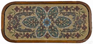 Victorian beaded trivet with a mahogany frame, 19