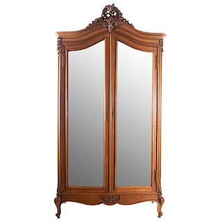Armario. Francia. SXX. Estilo Luis XV. En madera de nogal. Con 2 puertas abatibles con espejos de lunas biseladas. 253 x 133 x 50 cm.