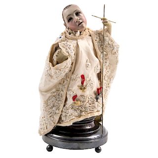 BABY JESUS. MEXICO, 19TH CENTURY. Wood “incarnation” with glass eyes and eyelashes. Includes 18 pieces of clothing.