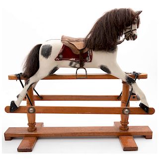 CHILD’S RIDING HORSE. MID-20TH CENTURY. Engraved in polychromed and lacquered wood with mobile iron applications.