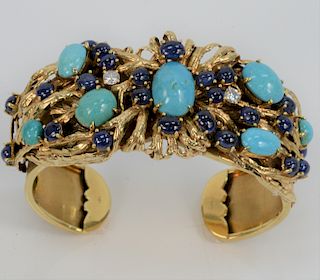 18 Karat Gold Cuff Bracelet Mounted with Two Diamonds, twenty- four cabochon cut blue sapphires, and seven cabochon cut turquoise. total weight 65.8 g