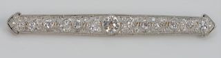 J.E. Caldwell Platinum and 18 Karat Gold Bar Pin, set with center diamond approximately 1 carat, flanked by two .20 carat diamonds on either side, sig