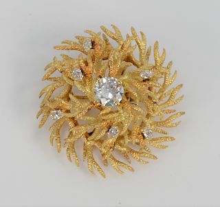 18 Karat Gold Brooch Set with Center Diamond, approximately 1.5 carats, surrounded by six small diamonds. diameter 1 1/2 inches.