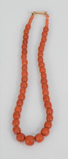 Red Coral Necklace, having gold clasp and faceted carved barrel beads of varying sizes. 13.9 millimeters - 7.45 millimeters plus small round beads len