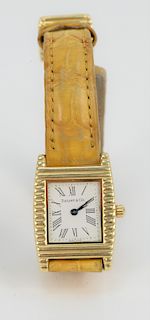 Tiffany and Company 18 Karat Gold Ladies Wristwatch, with alligator band and 18 karat gold Tiffany buckle. 21.7 millimeters x 23.9 millimeters.