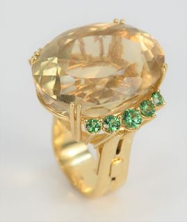 18 Karat Gold Cocktail Ring, with large oval stone flanked by five green stones, adjustable size. large stone 23.7millimeters x 30 millimeters.