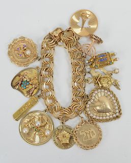 14 Karat Gold Charm Bracelet with 14 karat gold charms. length 7 3/4 inches, 118.4 grams.