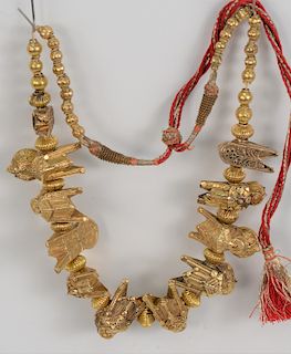 18 - 20 Karat Gold Necklace, having alternating figures and reeded suppressed beads, ending in round beads with red silk and metal cords, probably Ind