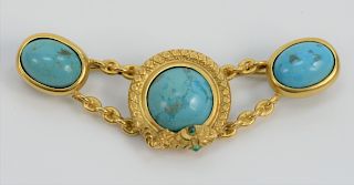 18 Karat Gold Brooch, mounted with three turquoise center surrounded by snake with green eyes, probably 19th century. length 2 1/4 inches, 11.4 grams.